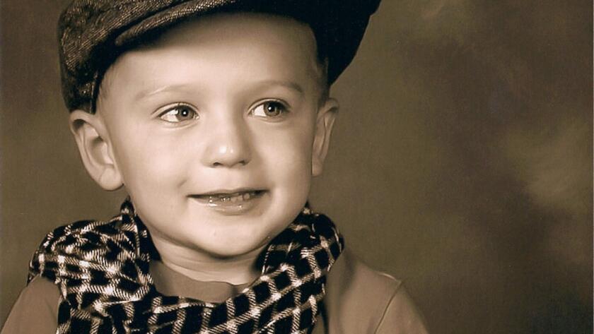 Jordan as a young child in vintage portrait photo before turning 18