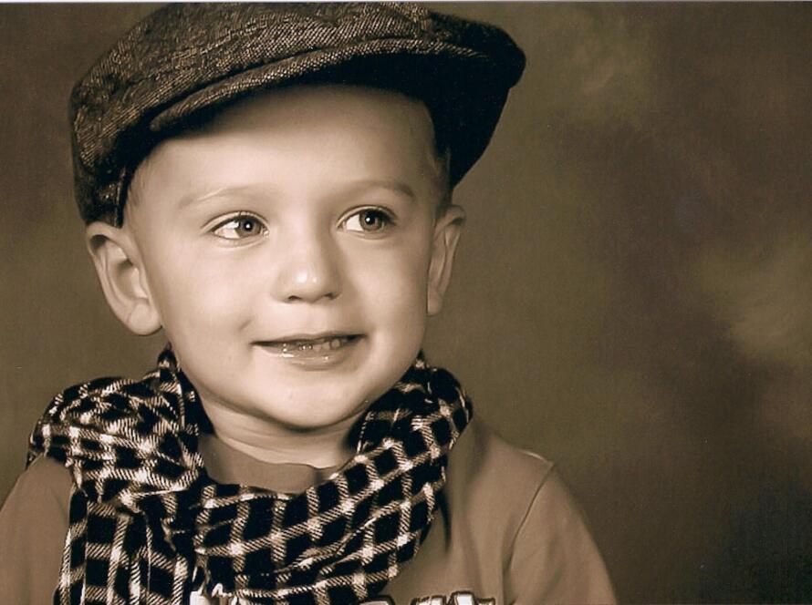 Jordan as a young child in vintage portrait photo before turning 18