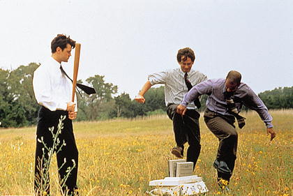 Employees destroying office printer symbolizing frustration with TPS reports in business