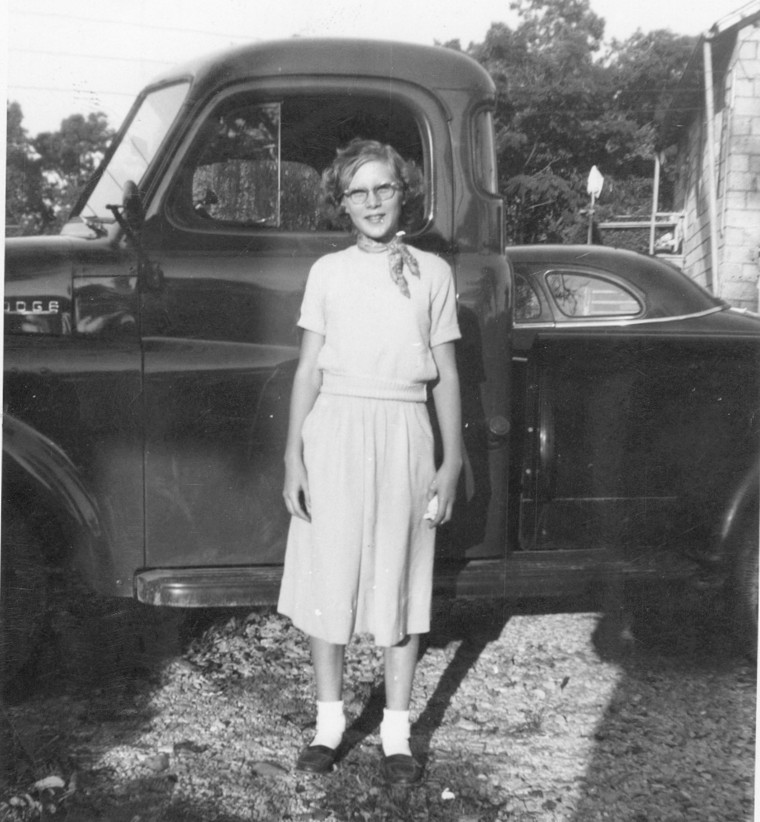 Wilma Gartrell standing beside her family truck in East Tennessee in the mid-1950s before leaving for her life beyond the farm