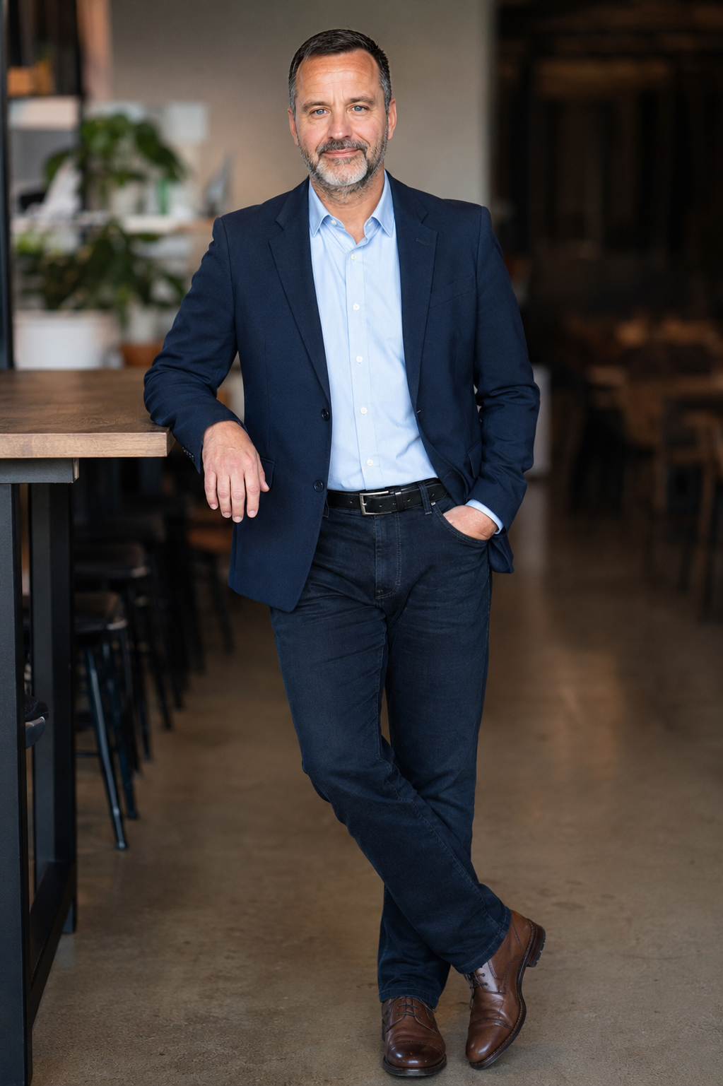 Ryan Gartrell standing in a modern business environment, operations consultant and Lean AI strategist.