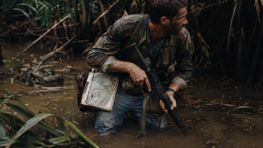 Vietnam-era operator in blue jeans moving through swamp, symbolizing business workarounds and field innovation.
